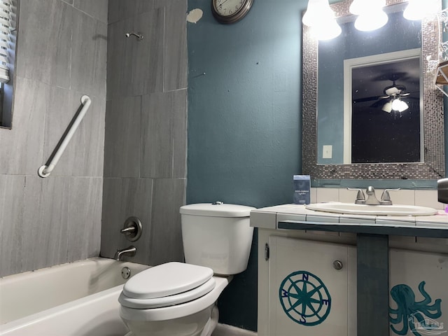 bathroom with toilet, bathing tub / shower combination, vanity, and a ceiling fan