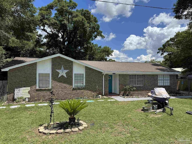 single story home featuring brick siding and a front lawn