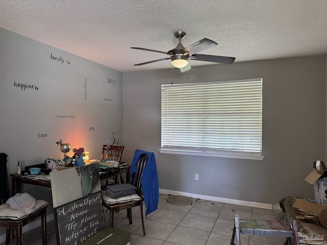office area with a ceiling fan, tile patterned flooring, a textured ceiling, and baseboards