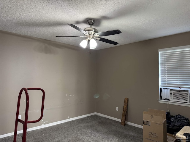 carpeted spare room with cooling unit, ceiling fan, a textured ceiling, and baseboards