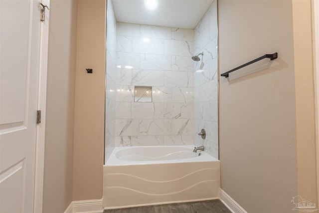 full bathroom with baseboards, shower / washtub combination, and wood finished floors