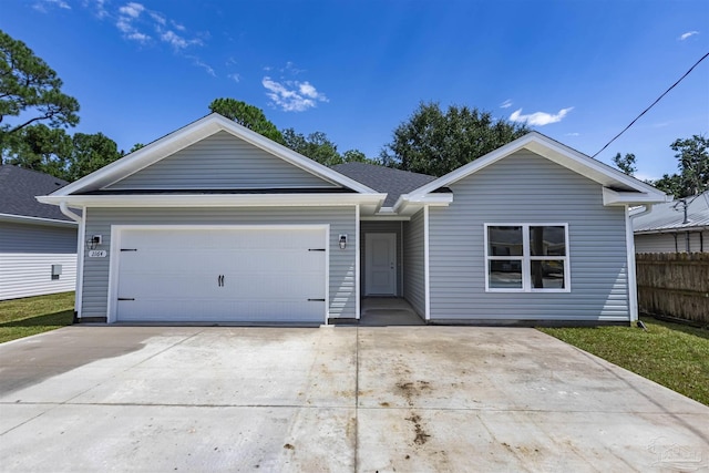 ranch-style house with a garage, driveway, roof with shingles, and fence