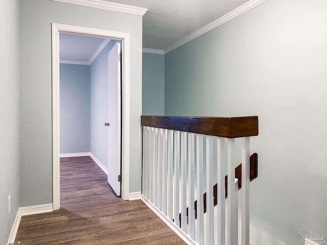 hall featuring crown molding, baseboards, and dark wood-style flooring