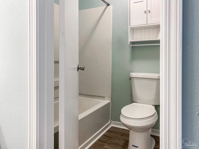 bathroom featuring wood finished floors and toilet