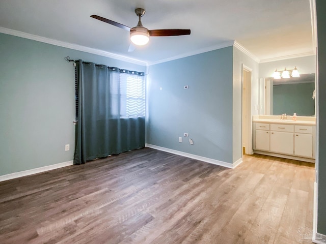 unfurnished bedroom with light wood-style floors, ornamental molding, baseboards, and ceiling fan