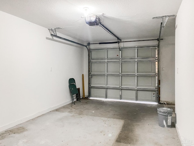 garage featuring baseboards and a garage door opener