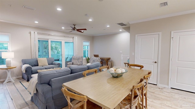 dining area featuring light hardwood / wood-style flooring, ornamental molding, and ceiling fan