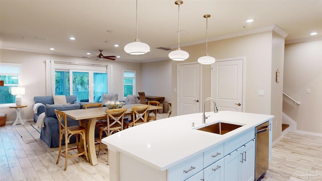 kitchen featuring sink, hanging light fixtures, stainless steel dishwasher, a kitchen island with sink, and white cabinets