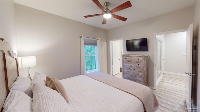 bedroom with light hardwood / wood-style flooring and ceiling fan