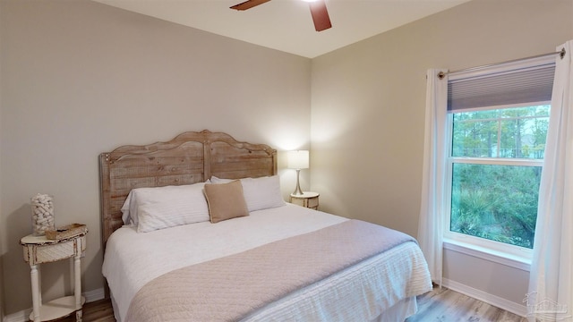 bedroom with ceiling fan and hardwood / wood-style floors