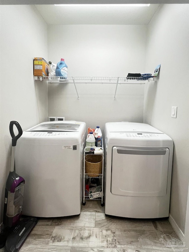 clothes washing area with washer and clothes dryer