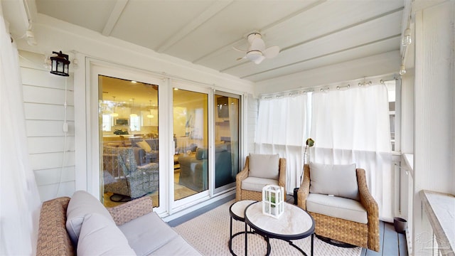 sunroom / solarium featuring ceiling fan