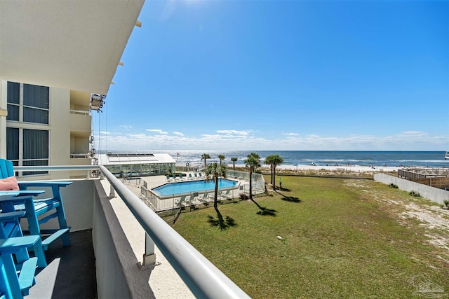 balcony with a water view and a beach view