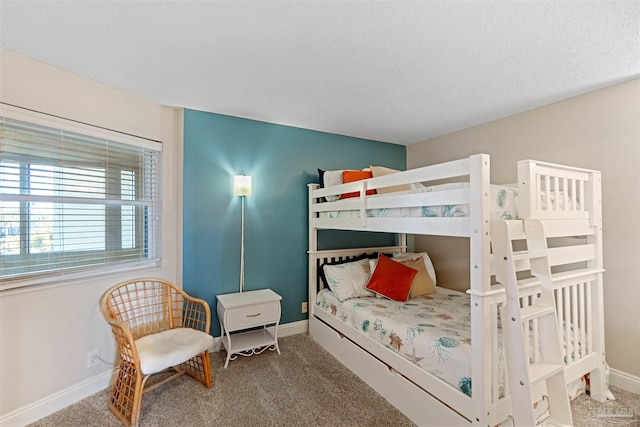 bedroom featuring a textured ceiling and carpet floors