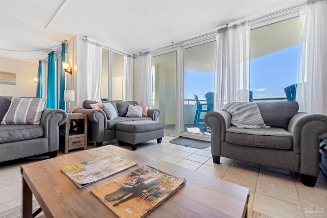 living room with a textured ceiling, a healthy amount of sunlight, and light tile patterned floors