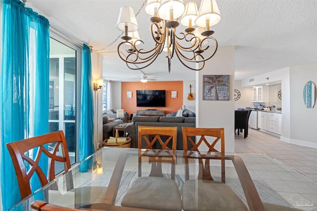 dining area with a healthy amount of sunlight, a textured ceiling, and ceiling fan with notable chandelier