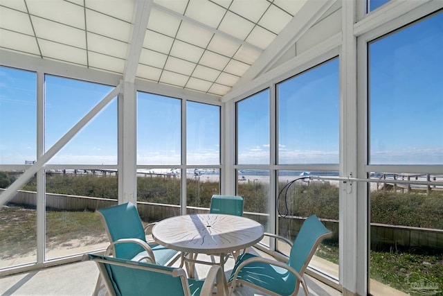 unfurnished sunroom with lofted ceiling and plenty of natural light