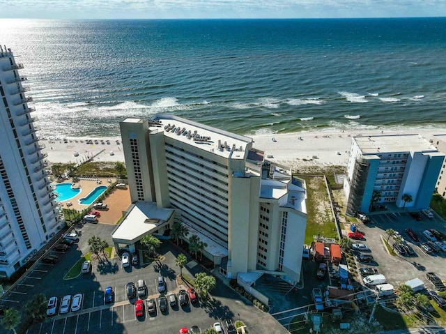 birds eye view of property featuring a water view and a beach view