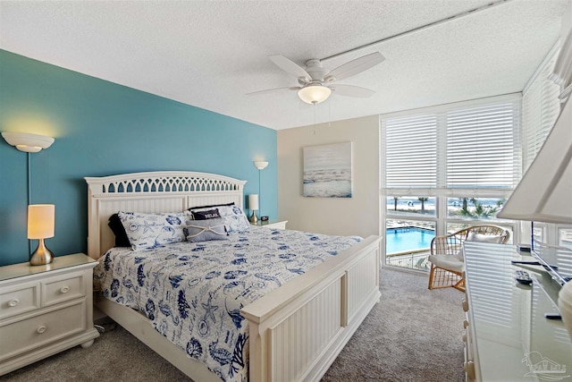 bedroom featuring a textured ceiling, carpet flooring, and ceiling fan