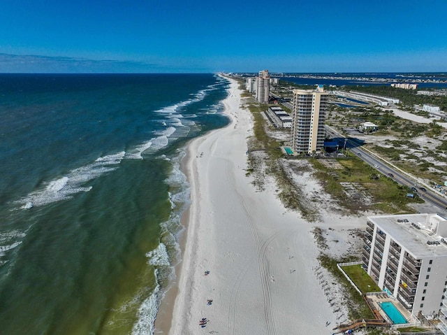 aerial view with a water view and a beach view