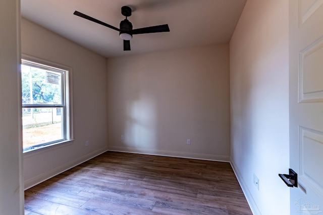 empty room featuring baseboards, a ceiling fan, and wood finished floors