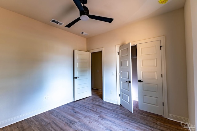 unfurnished bedroom with visible vents, baseboards, and wood finished floors