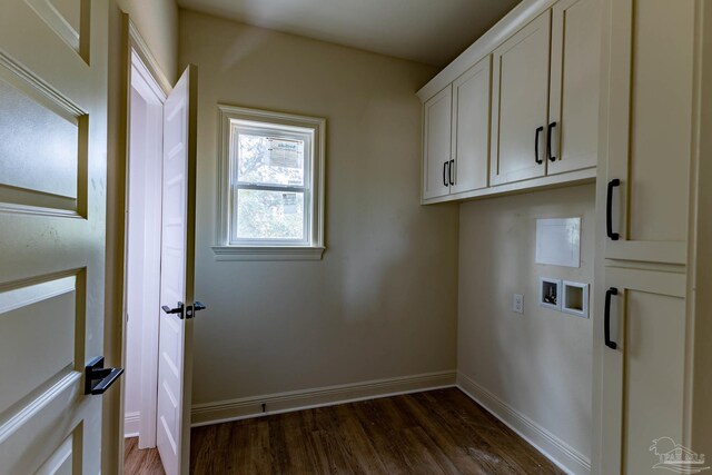 clothes washing area featuring washer hookup, cabinet space, dark wood-style flooring, and baseboards