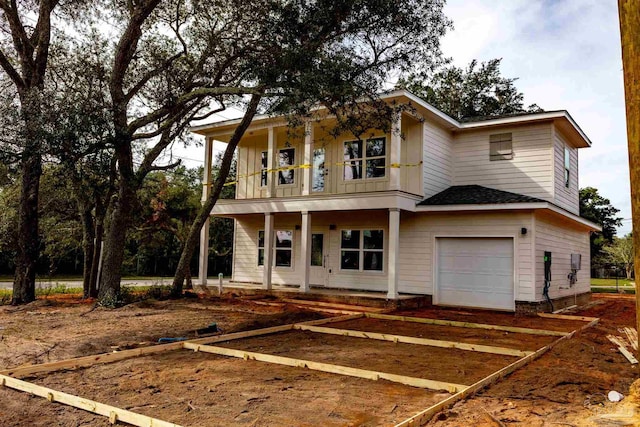 view of front of property featuring a garage and a balcony