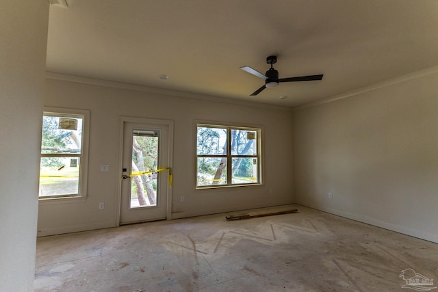 spare room with a ceiling fan, crown molding, and baseboards