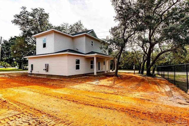 back of house with fence