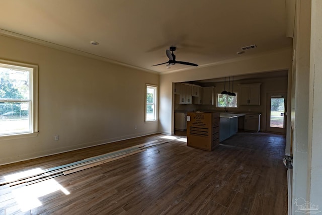 unfurnished living room featuring visible vents, crown molding, ceiling fan, and dark wood-style flooring