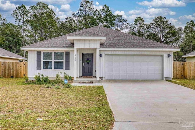 single story home featuring an attached garage, a shingled roof, fence, driveway, and a front yard