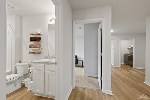 bathroom with visible vents, wood finished floors, and vanity