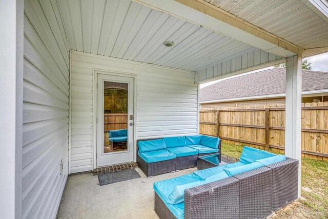 view of patio featuring outdoor lounge area and fence