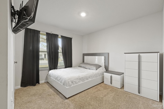 bedroom with carpet and baseboards