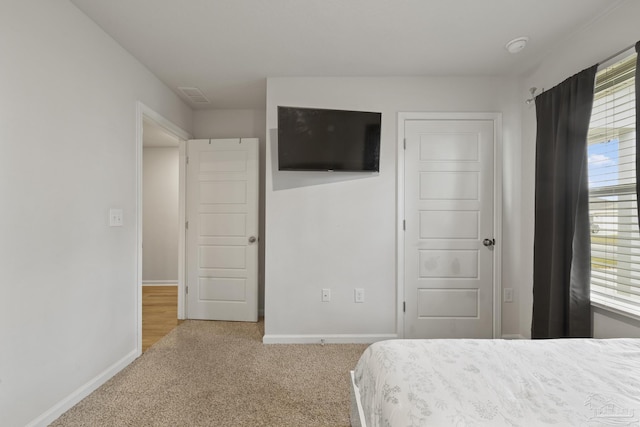 bedroom featuring carpet flooring, visible vents, and baseboards