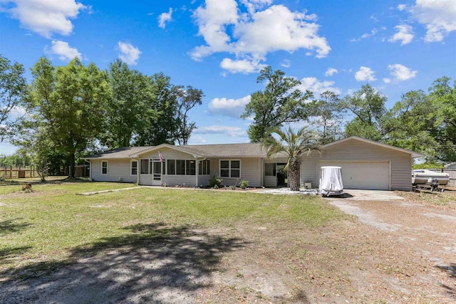 single story home featuring an attached garage, driveway, a sunroom, and a front yard
