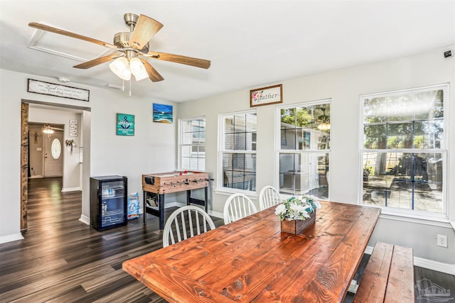 dining space with ceiling fan, baseboards, and dark wood-style floors