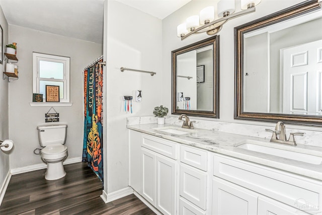 full bath featuring wood finished floors, baseboards, a sink, and toilet