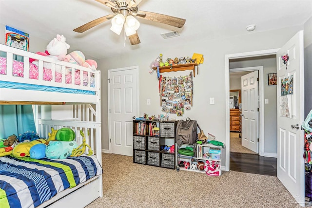 bedroom with baseboards, a ceiling fan, visible vents, and carpet floors
