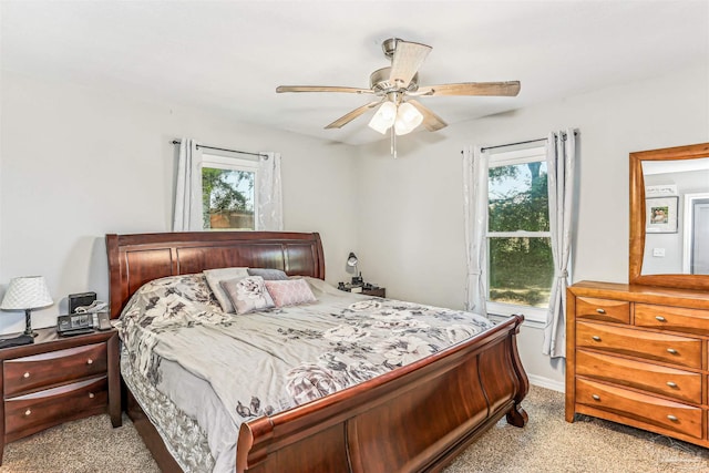 bedroom featuring light colored carpet and ceiling fan