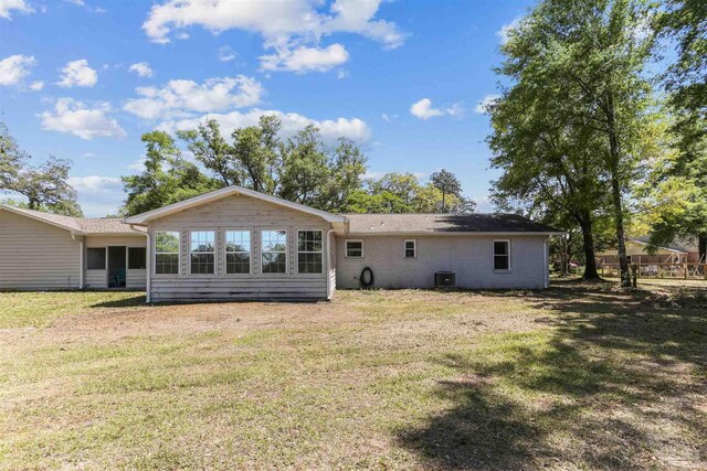 back of house with a yard and central AC unit