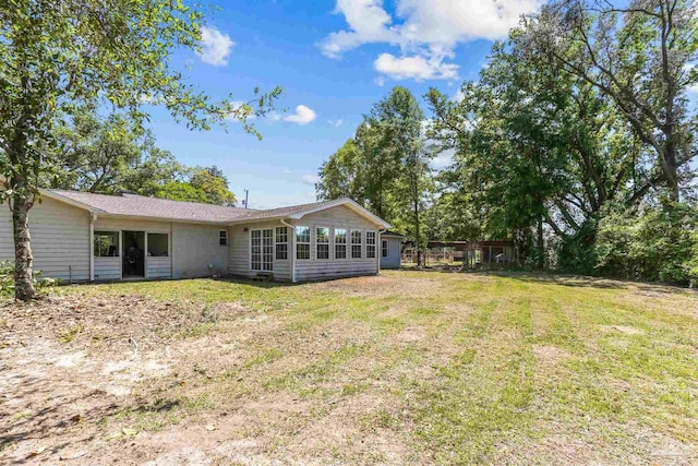 rear view of house with a lawn