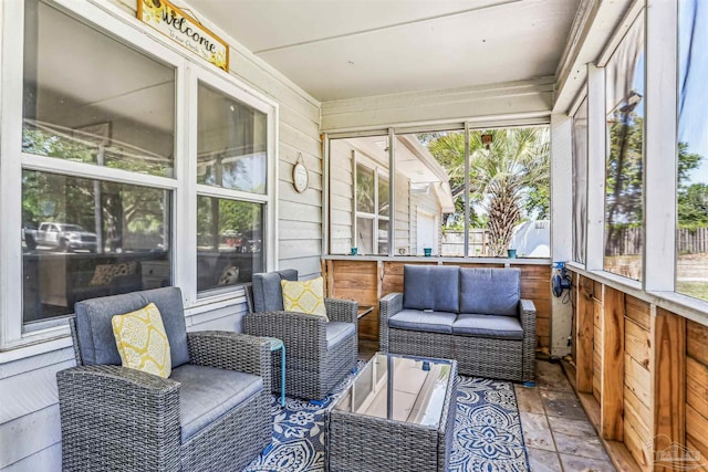 sunroom / solarium with an outdoor living space and a healthy amount of sunlight