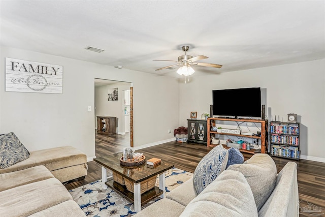 living area featuring wood finished floors, visible vents, baseboards, and ceiling fan