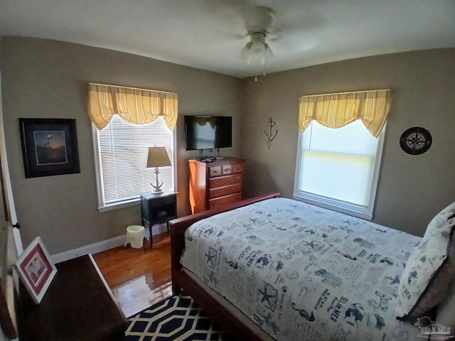 bedroom with ceiling fan and hardwood / wood-style flooring