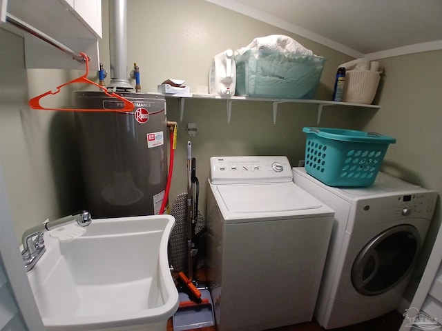 laundry area with independent washer and dryer, electric water heater, and sink