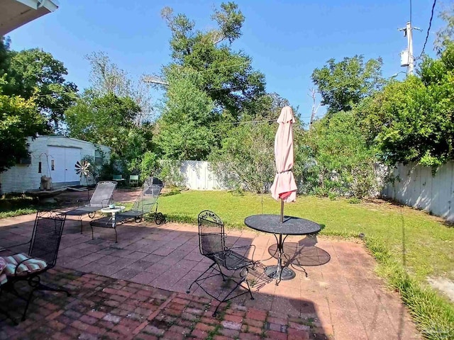 view of patio / terrace featuring a storage unit