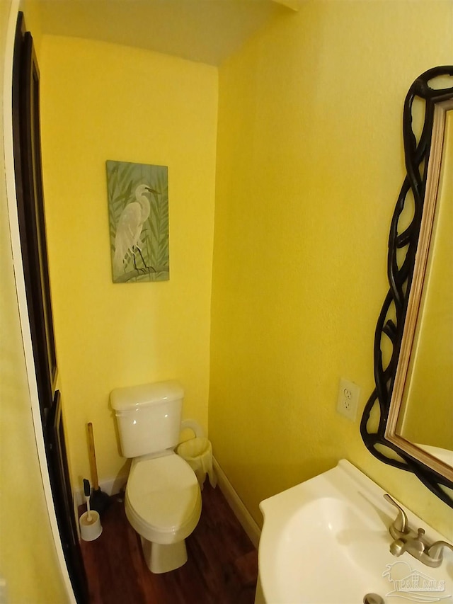 bathroom with sink, hardwood / wood-style flooring, and toilet