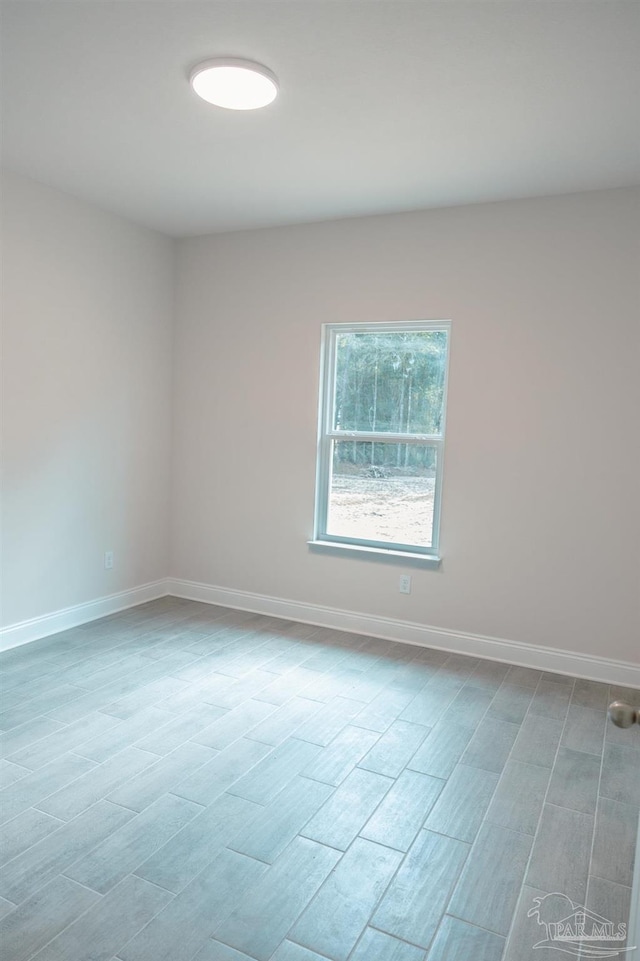 empty room featuring baseboards